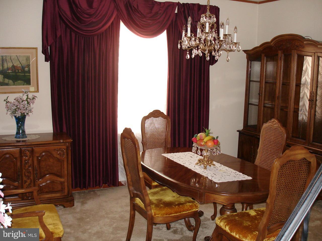 373 Nicholson Road Baltimore, MD 21221 - Photo 11 of 25 a view of a dining room with furniture and chandelier
