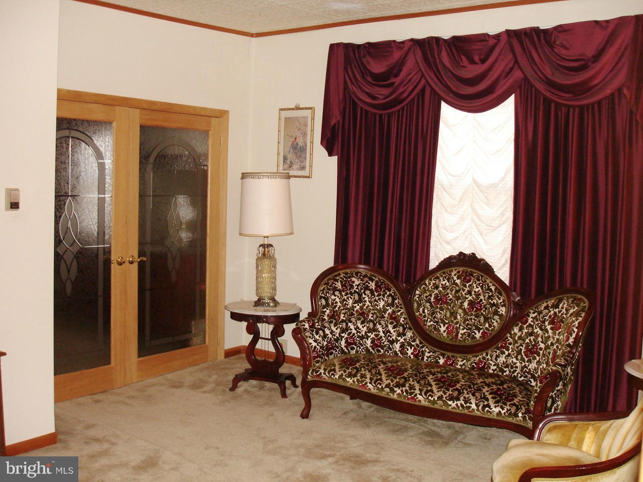 373 Nicholson Road Baltimore, MD 21221 - Photo 12 of 25 a bedroom with a bed and a chair