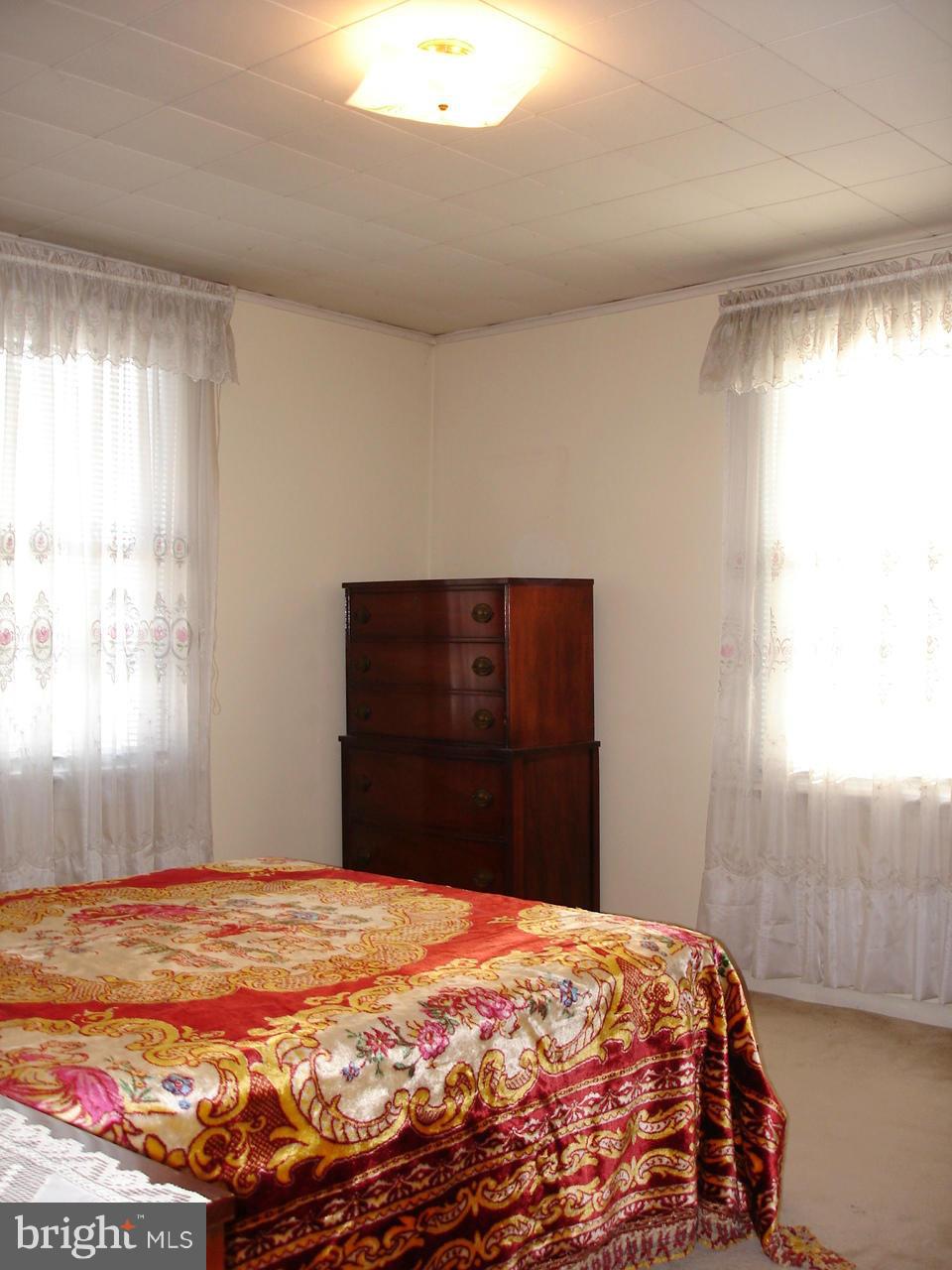 373 Nicholson Road Baltimore, MD 21221 - Photo 14 of 25 a bedroom with a bed and a window