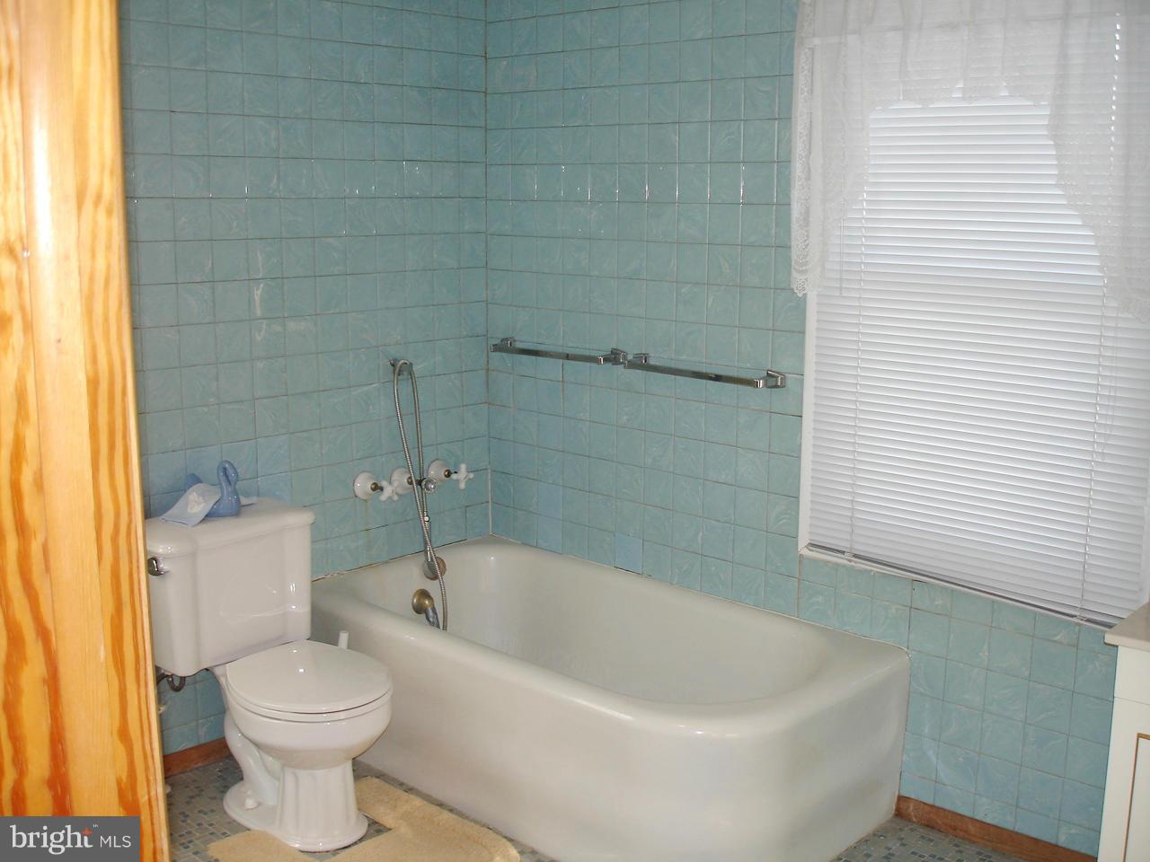 373 Nicholson Road Baltimore, MD 21221 - Photo 15 of 25 a white bath tub sitting next to a toilet