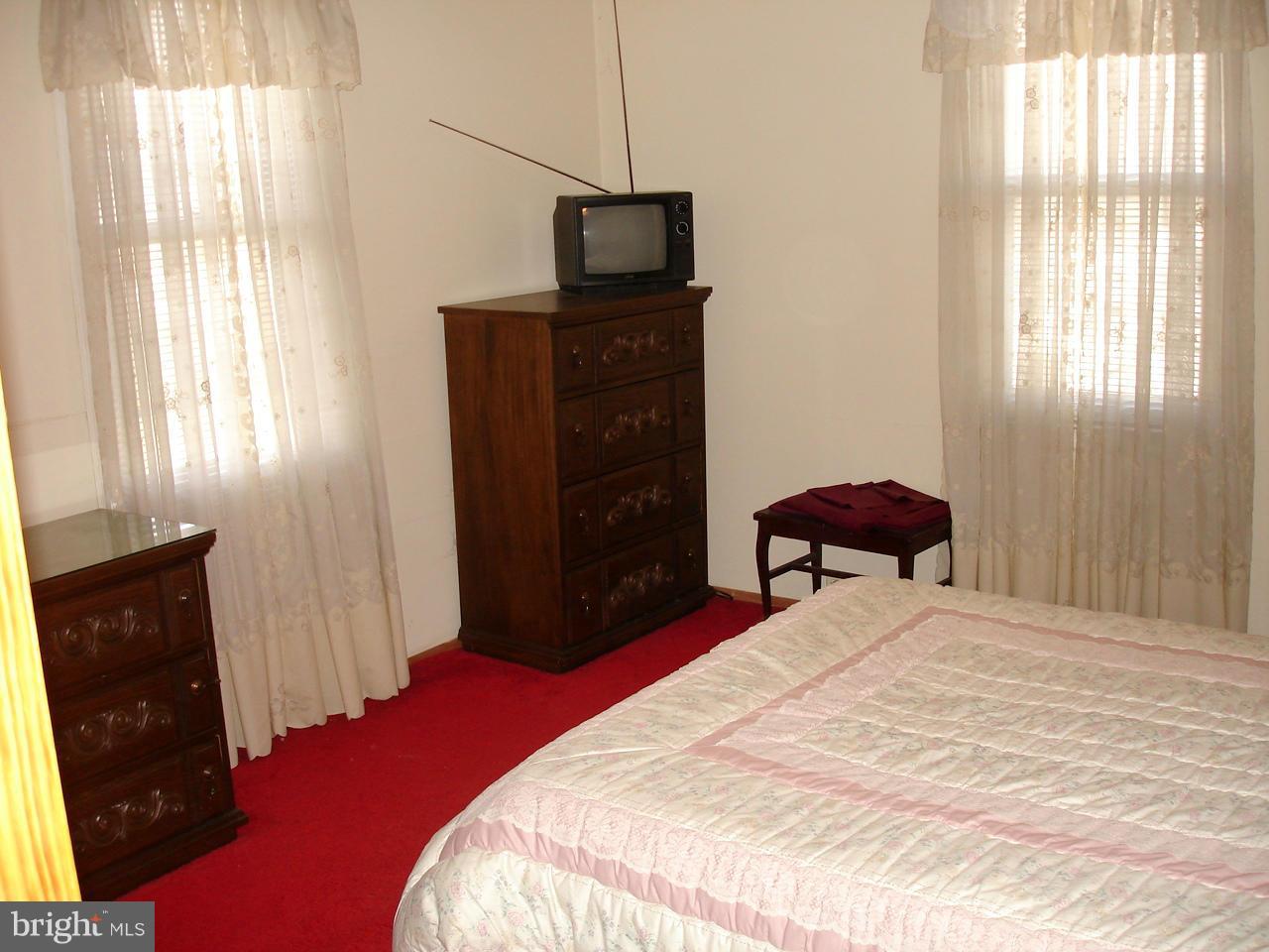 373 Nicholson Road Baltimore, MD 21221 - Photo 16 of 25 a bedroom with a bed and a television