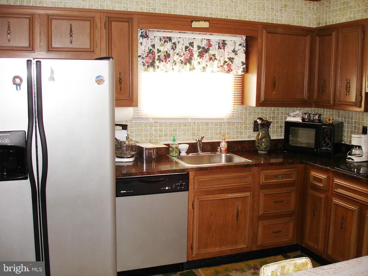 373 Nicholson Road Baltimore, MD 21221 - Photo 18 of 25 a kitchen with stainless steel appliances granite countertop a refrigerator and a sink