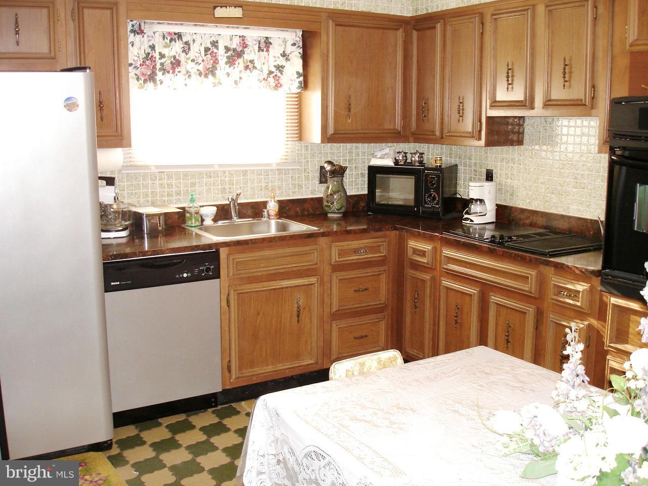 373 Nicholson Road Baltimore, MD 21221 - Photo 4 of 25 a kitchen with stainless steel appliances granite countertop a sink stove and refrigerator