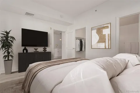 a bedroom with a large bed and a flat screen tv