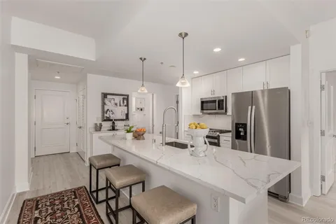 a kitchen with stainless steel appliances a refrigerator sink and stove