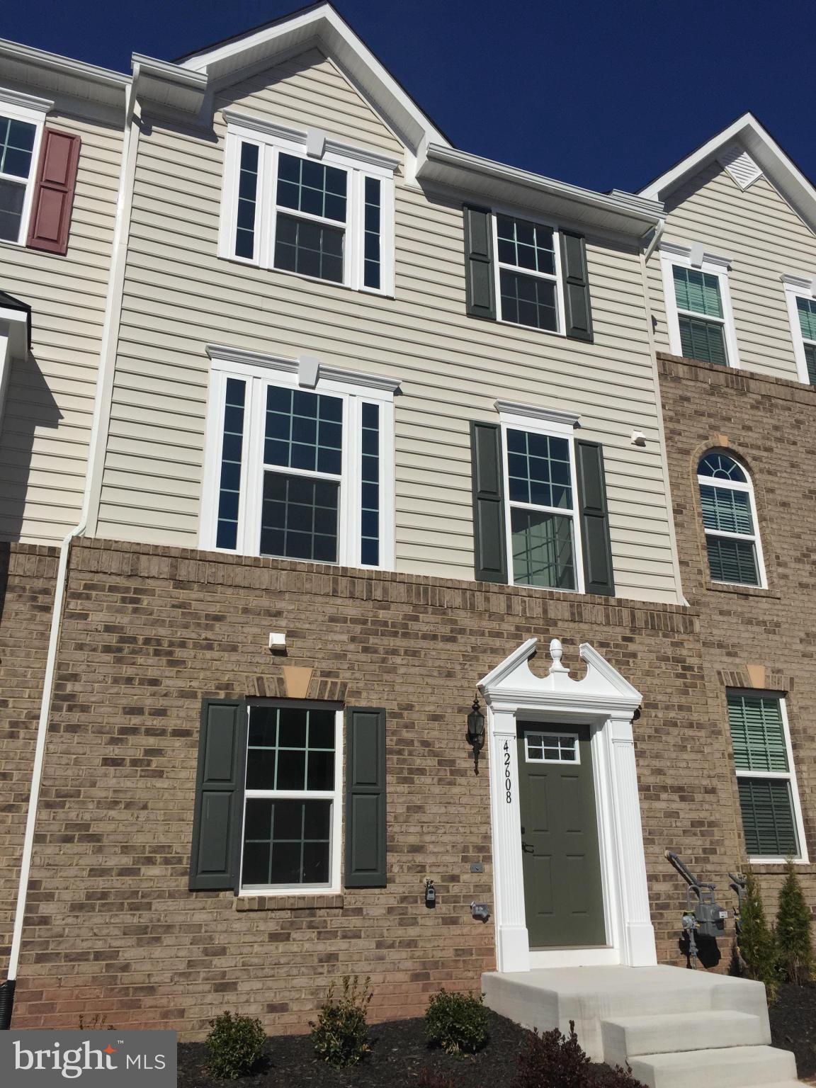 42608 Smokey Embers Terrace Sterling, VA 20166 - Photo 1 of 13 a front view of a house with a yard
