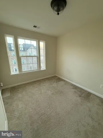 an empty room with a empty space and windows