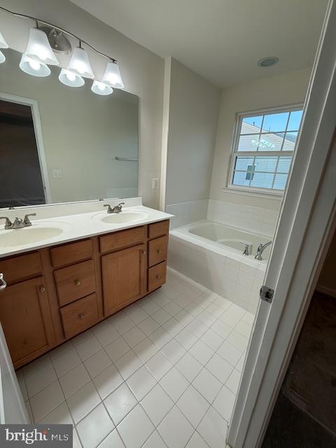42608 Smokey Embers Terrace Sterling, VA 20166 - Photo 10 of 13 a spacious bathroom with a double vanity sink a mirror and a bathtub