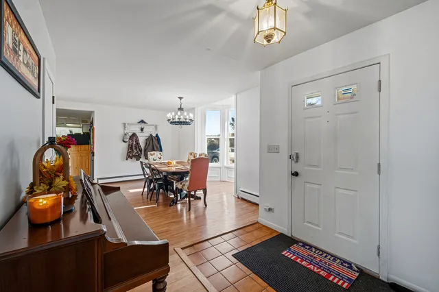 a view of a dining room with furniture and chandelier