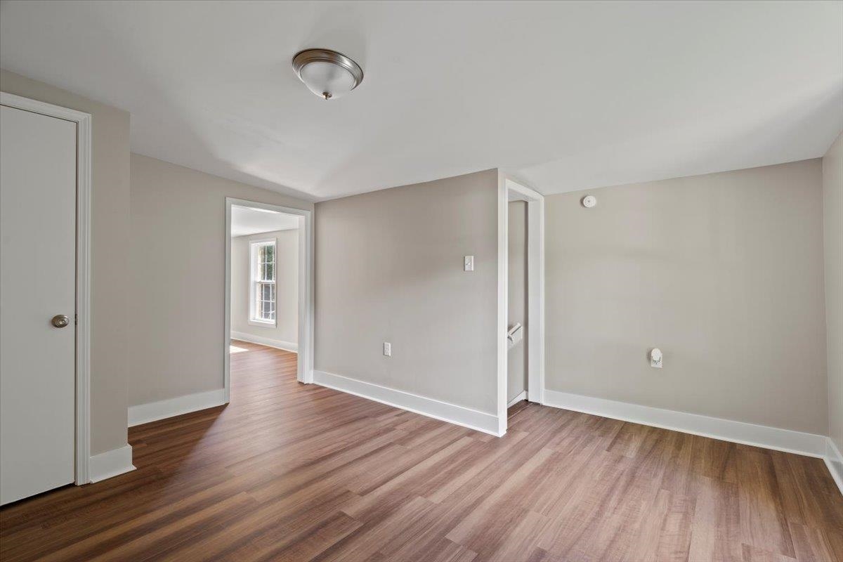 101 Sivil Circle Covington, TN 38019 - Photo 11 of 40 an empty room with wooden floor and windows