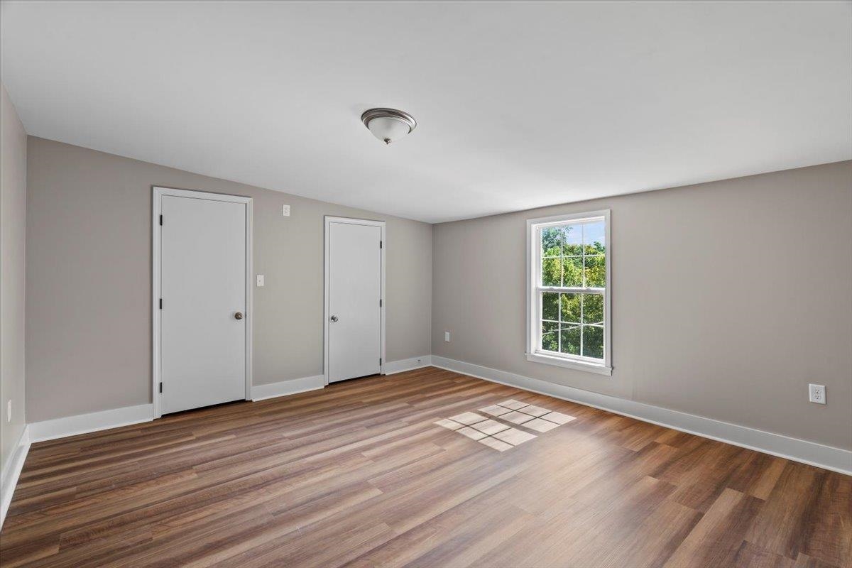 101 Sivil Circle Covington, TN 38019 - Photo 12 of 40 an empty room with wooden floor and windows
