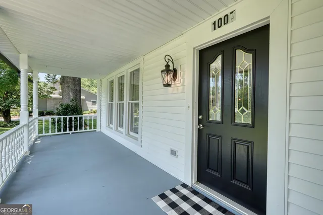 a bedroom with furniture and a wooden floor