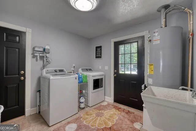 a kitchen with granite countertop a refrigerator and cabinets