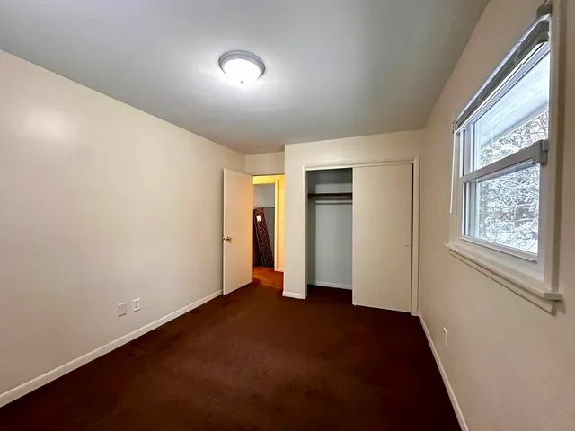 an empty room with closet area