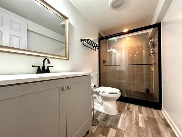 a bathroom with a sink toilet and shower