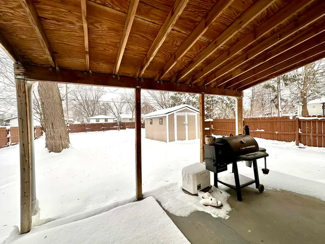 a living room with a large window and a table and chairs