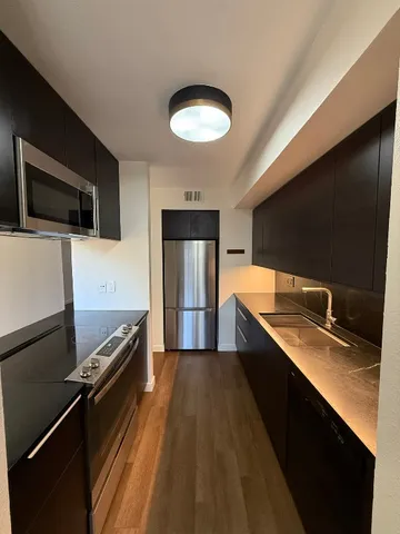 a kitchen with a sink appliances and cabinets