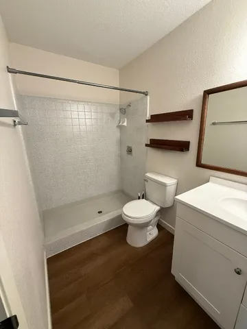 a white toilet sitting next to a bathroom sink