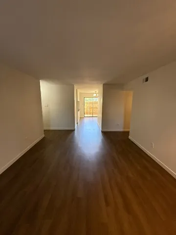 a view of wooden floor and windows in an empty room