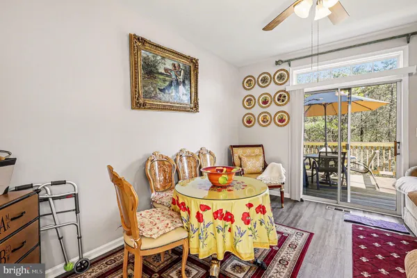 a dining room with furniture a flat screen tv and a floor to ceiling window