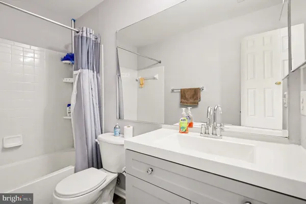 a bathroom with a sink vanity mirror and toilet