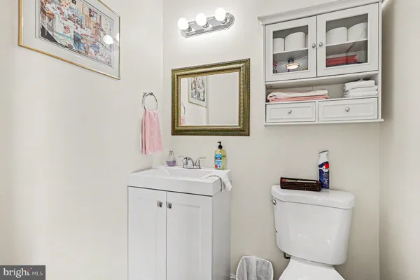 a bathroom with a toilet a sink and a mirror