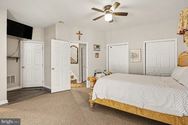 a bedroom with a bed bed and a walk in closet