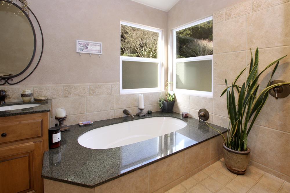 5 Nunes Road Watsonville, CA 95076 - Photo 17 of 41 a bathroom with a granite countertop sink and a mirror