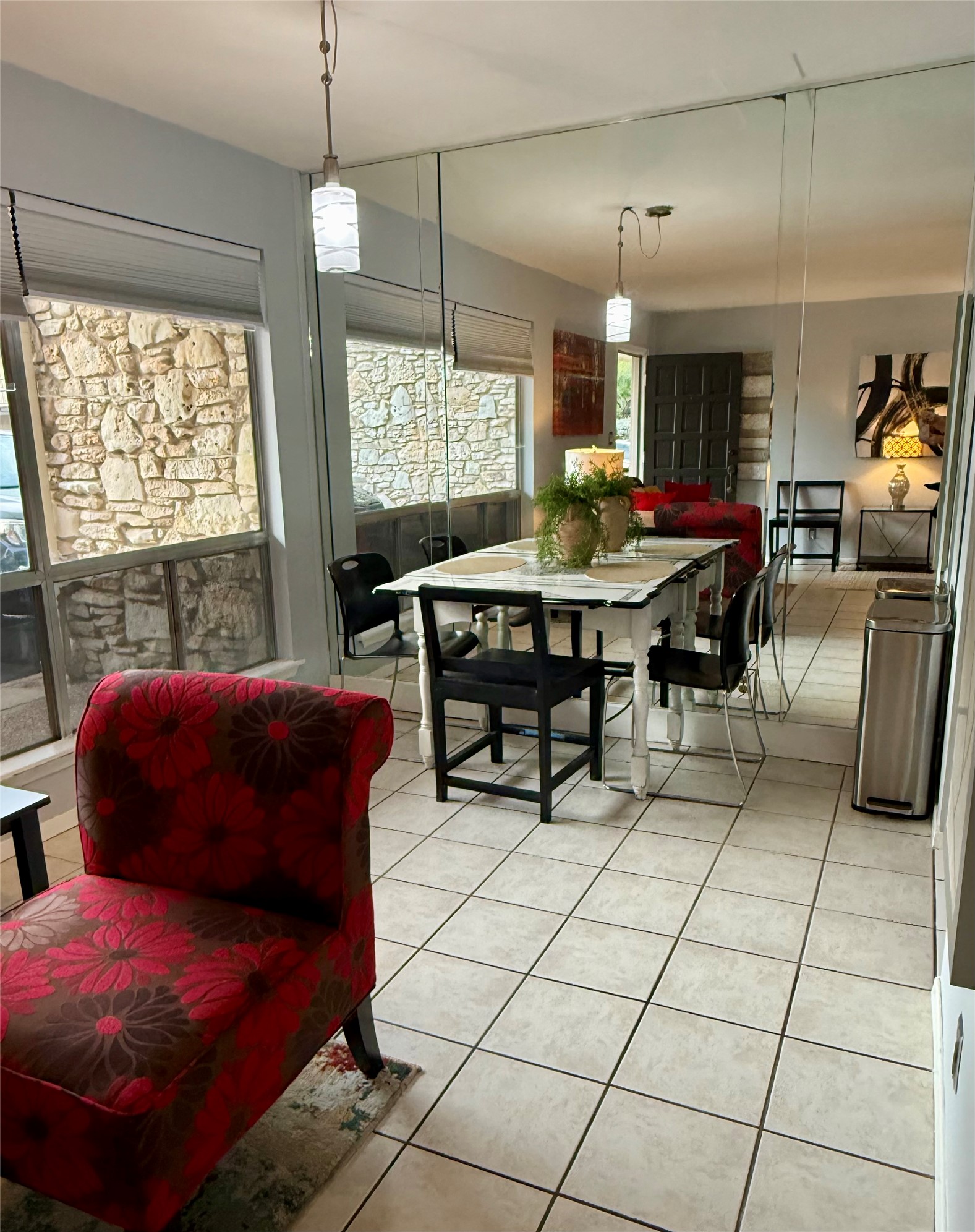 500 East Riverside Drive, Unit 149 Austin, TX 78704 - Photo 2 of 26 Tiled floors and large mirrored panels define this inviting dining area.
