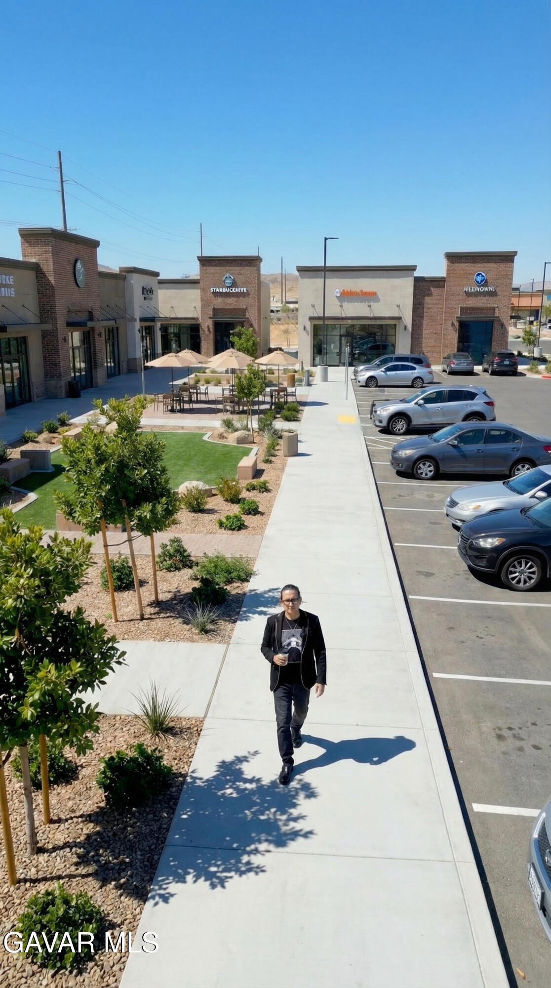 Sierra Highway, Unit R4 Palmdale, CA 93550 - Photo 21 of 23 a living room with furniture and a flat screen tv