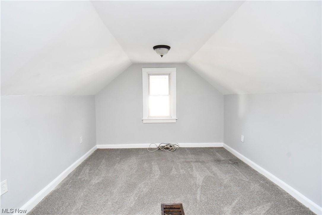 3193 Joslyn Road Cleveland, OH 44111 - Photo 36 of 41 Additional living space featuring dark colored carpet and lofted ceiling