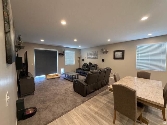 118 Tram Rock Rd. Lake Point, UT 84074 - Photo 12 of 34 Open-concept living space featuring recessed lighting, a sliding glass door with a privacy shade, and two windows with blinds