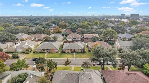 an aerial view of residential houses with outdoor space and swimming pool