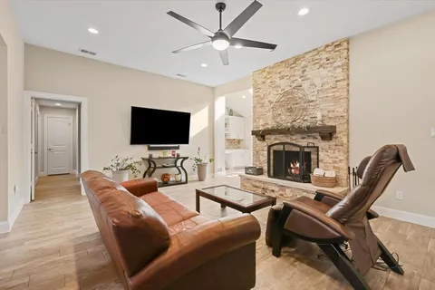 a living room with furniture a fireplace and a flat screen tv