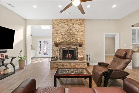 a living room with furniture a flat screen tv and a fireplace