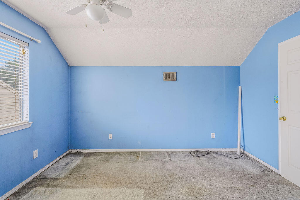 53 4th Street Shalimar, FL 32579 - Photo 20 of 47 an empty room with a ceiling fan and a window