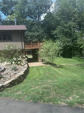a view of house with yard