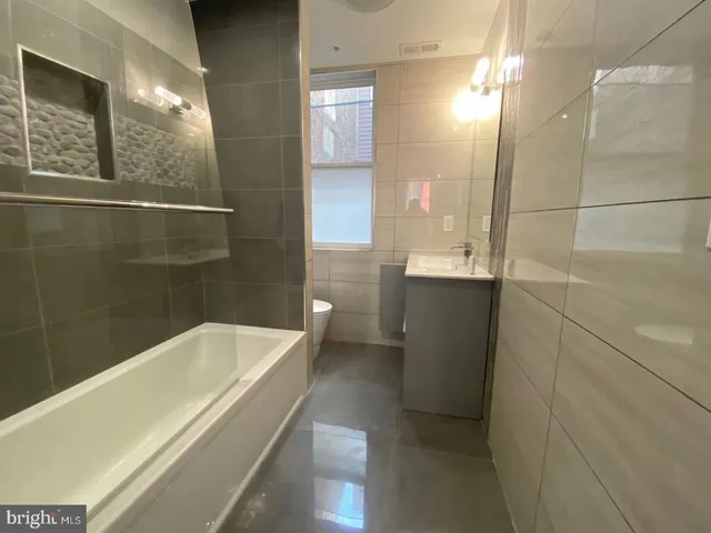 a bathroom with a bathtub and shower
