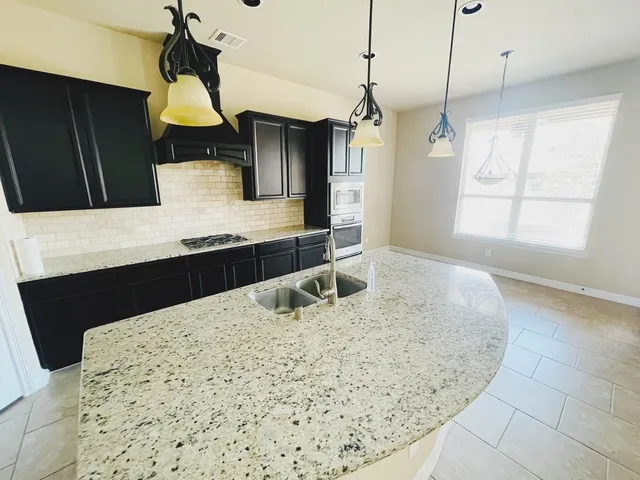 a kitchen with a sink a refrigerator and window