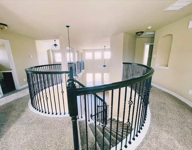 a view of a hallway with furniture