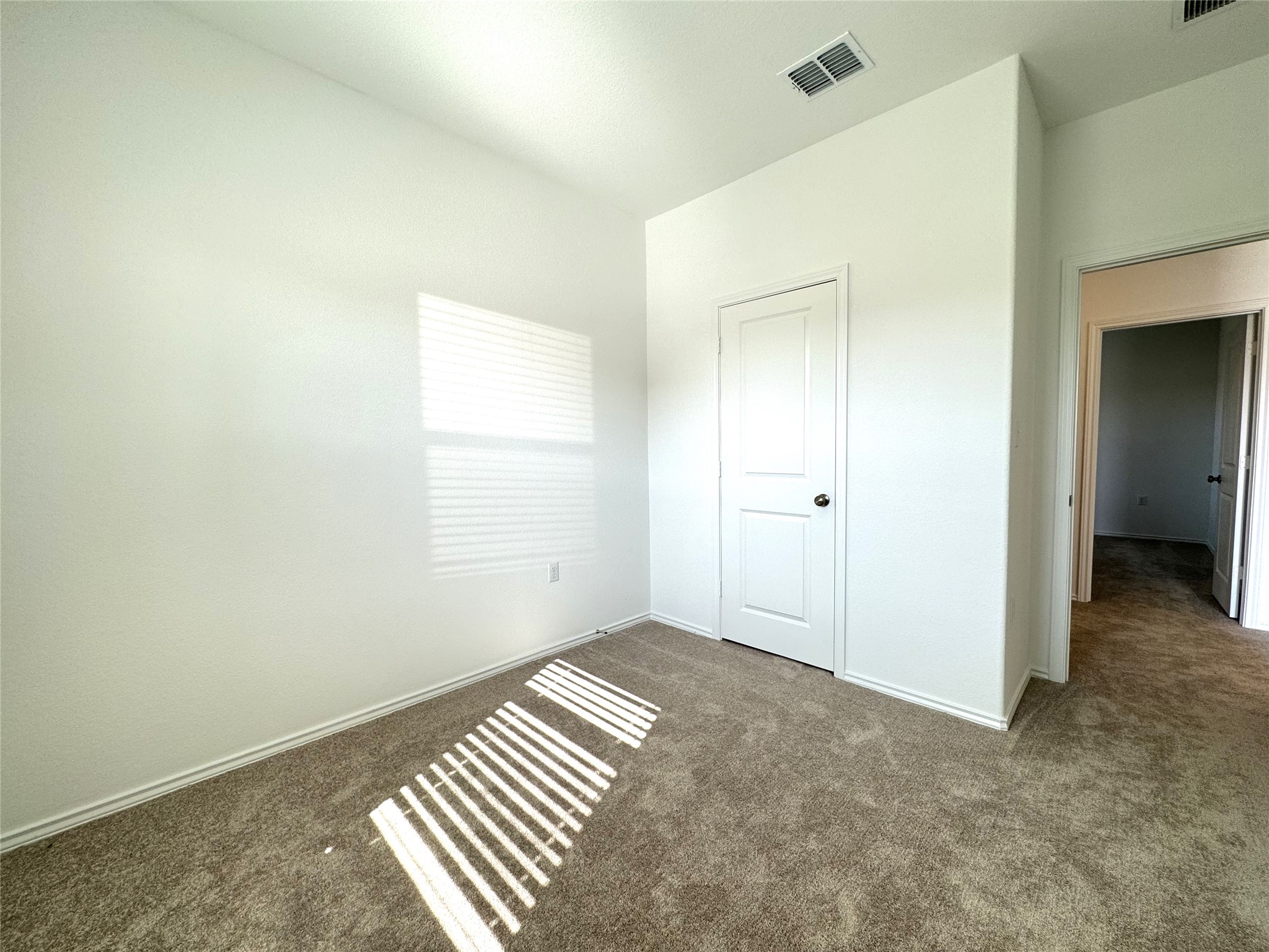 14408 Koti Way Pflugerville, TX 78660 - Photo 10 of 14 Unfurnished bedroom featuring dark carpet and baseboards