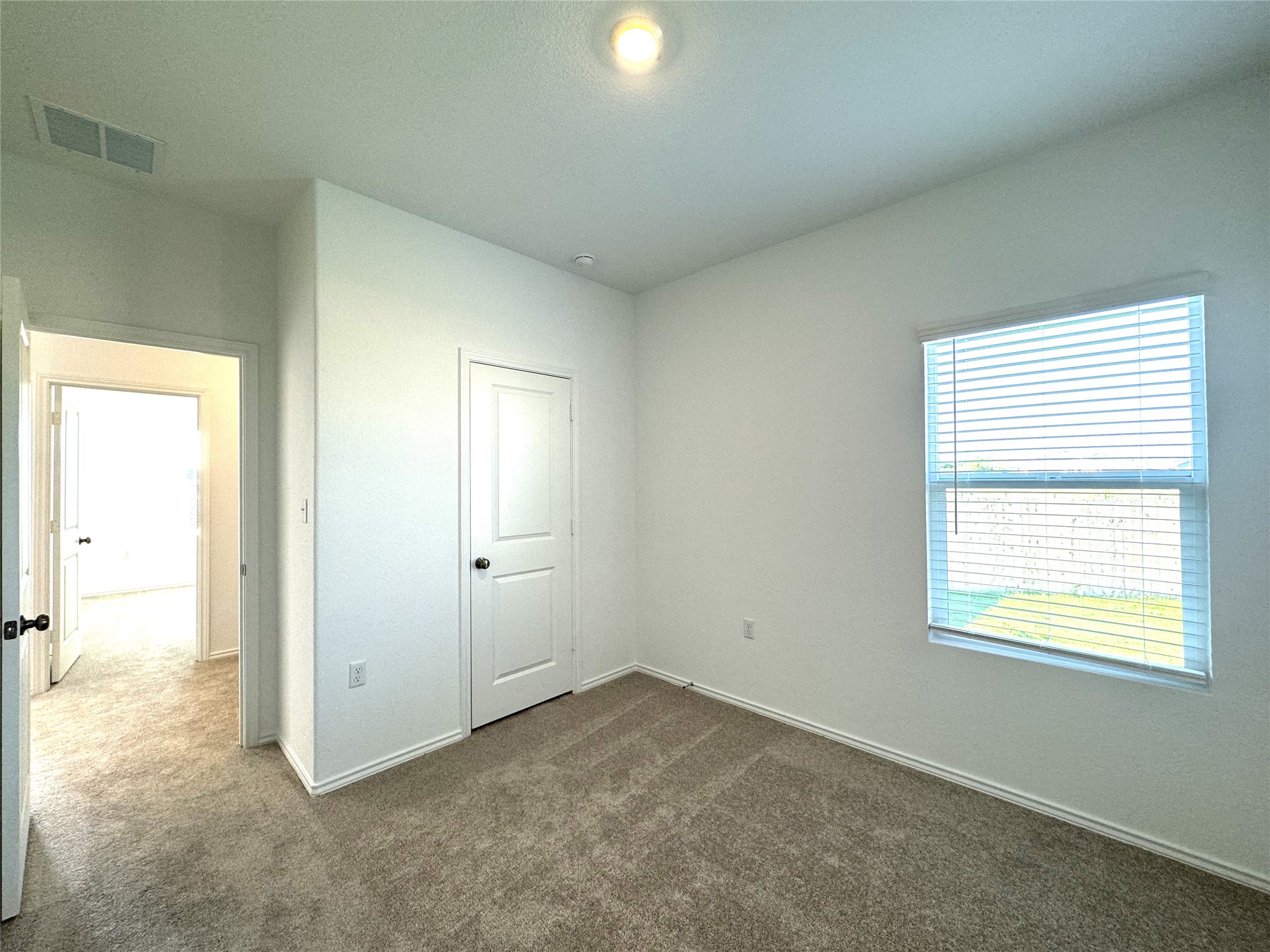 14408 Koti Way Pflugerville, TX 78660 - Photo 11 of 14 Unfurnished bedroom with dark colored carpet and baseboards