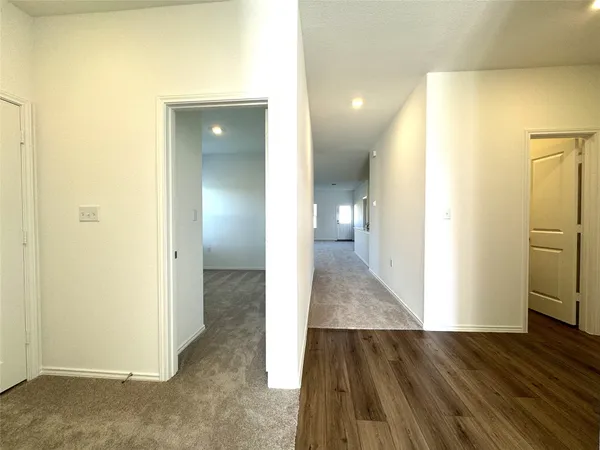 a view of a hallway with wooden floor