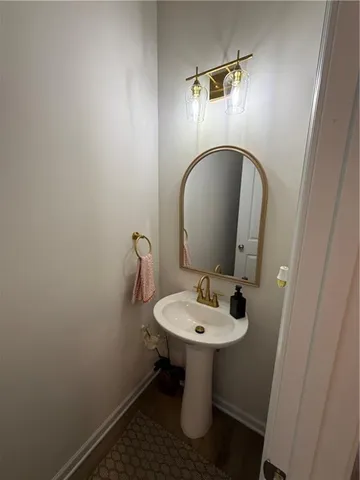 a bathroom with a sink toilet and a mirror