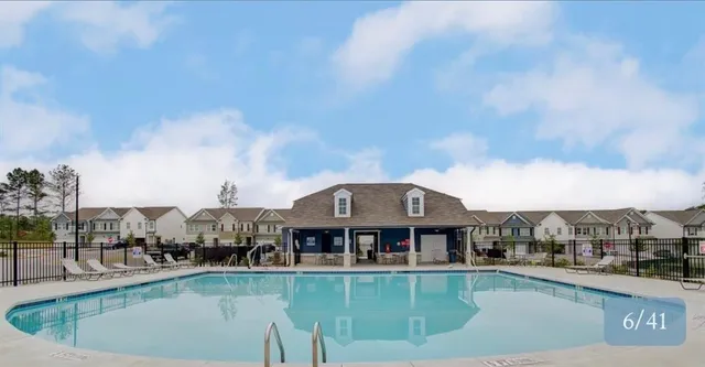 a view of a swimming pool with outdoor seating