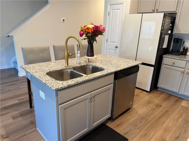 a kitchen with sink and a mirror