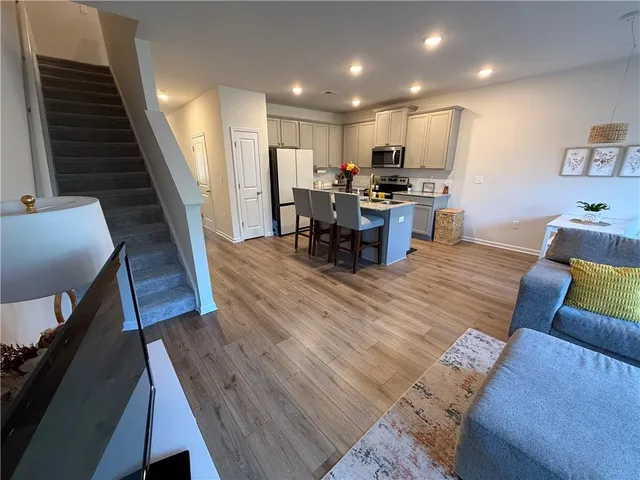 a living room with furniture and kitchen view