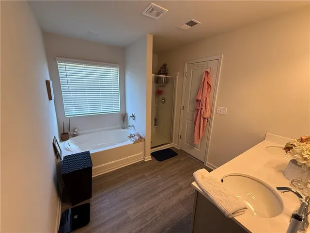 a bathroom with a tub sink and a mirror