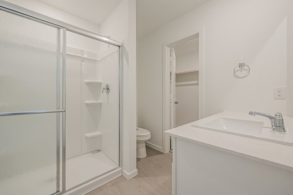 621 Craven Street Conroe, TX 77316 - Photo 9 of 16 a bathroom with a sink a toilet and shower
