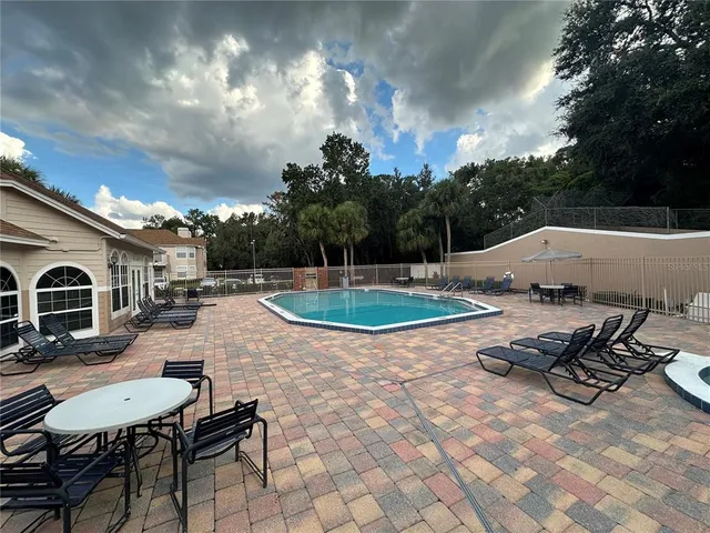 a view of a backyard with sitting area